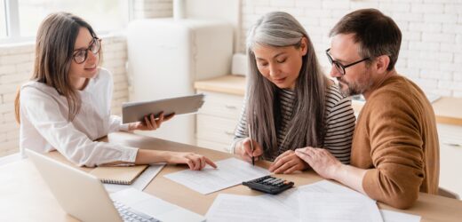 Insurance agent consulting mature family couple, discussing health insurance, signing contract deal